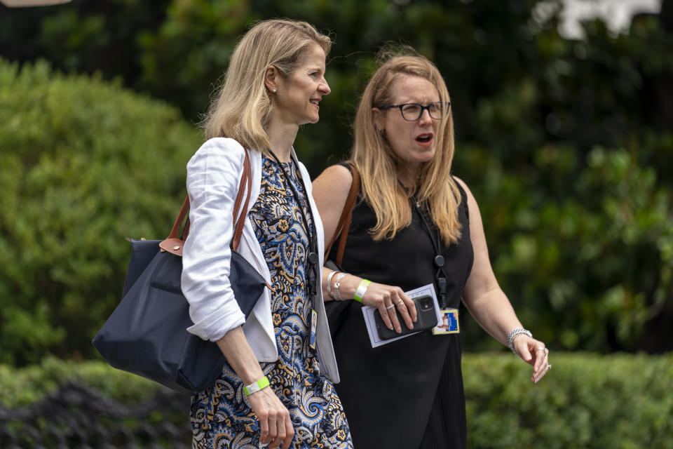 FILE - Assistant to the President and White House Counsel Dana Remus, left, and Assistant to the President and Deputy Chief of Staff Jen O'Malley Dillon, right, walk toward Marine One on the South Lawn of the White House in Washington to join President Joe Biden for a short trip to Andrews Air Force Base, Md., July 13, 2021. O'Malley Dillon coordinates strategy among the White House, the Democratic National Committee and an array of outside party groups. (AP Photo/Andrew Harnik, File)