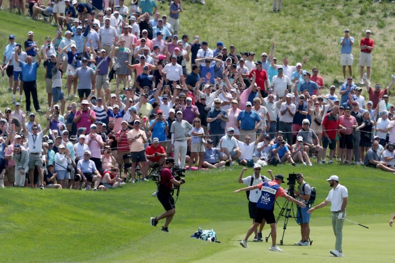 Scottie Scheffler (R) celebrates with his caddie after hitting a shot during the first round of the 2024 PGA Championship on Thursday at Valhalla Golf Club on Thursday in Louisville, Ky. Photo by John Sommers II/UPI