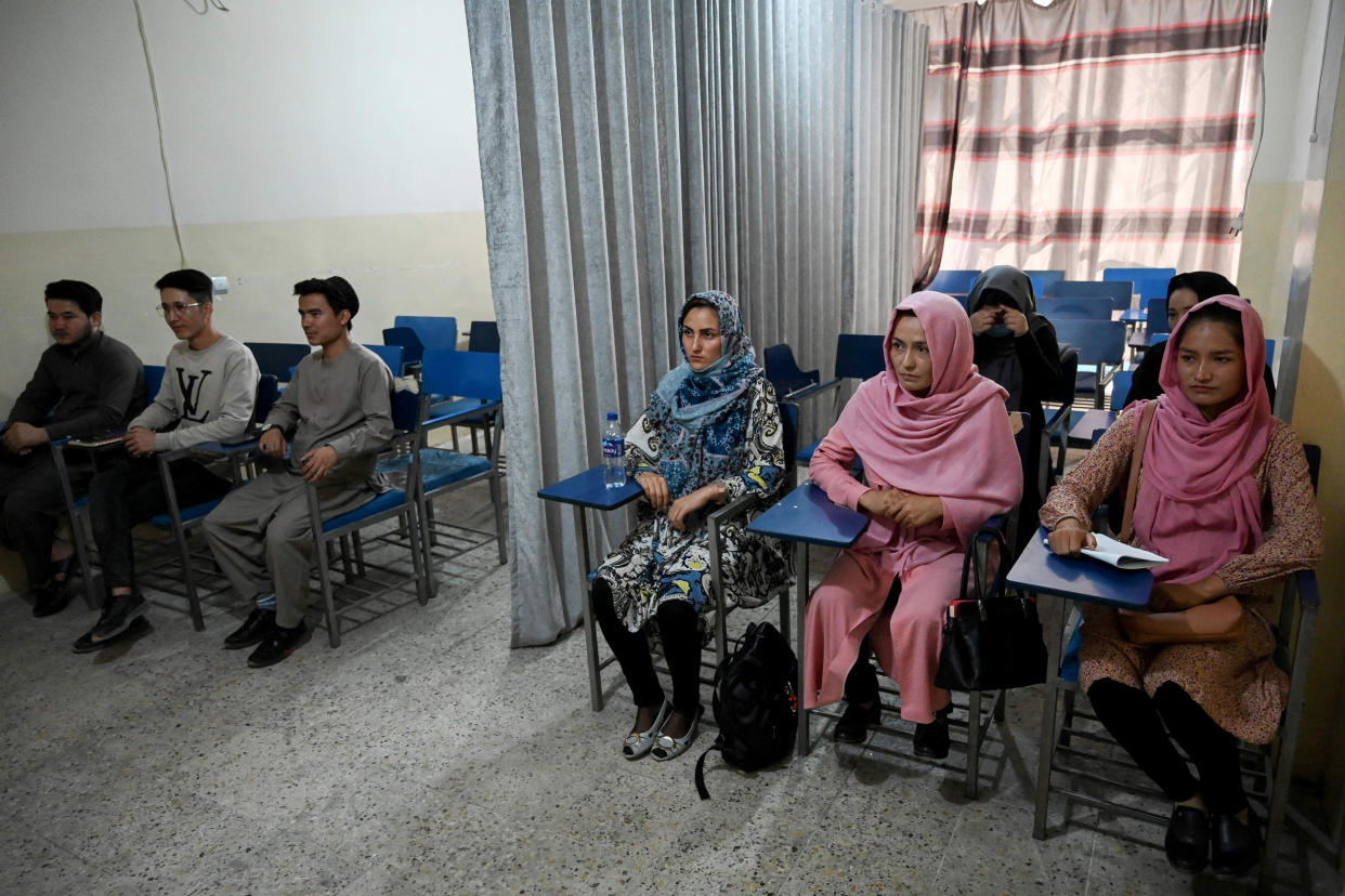 Image: Students attend a class divided by a curtain separating males and females at a private university in Kabul on September on Tuesday. (Aamir Qureshi / AFP via Getty Images)