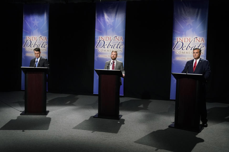 Libertarian James Sceniak, middle, speaks as Indiana Republican Sen. Todd Young, left, and Democrat Thomas McDermott listen during a U.S. Senate debate Sunday, Oct. 16, 2022, in Indianapolis. (AP Photo/Darron Cummings, Pool)