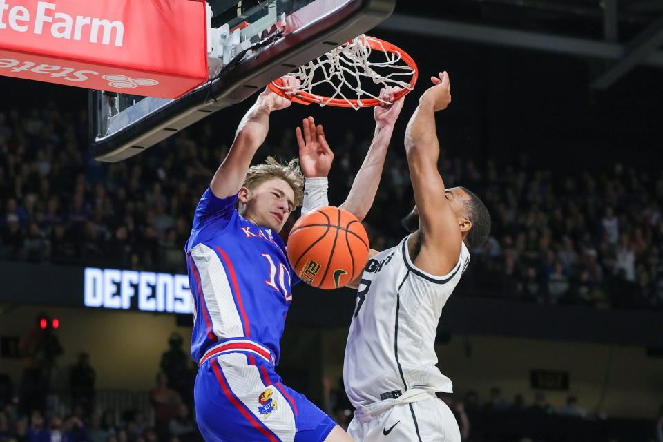 Jan 10, 2024; Orlando, Florida, USA; Kansas Jayhawks guard Johnny Furphy (10) dunks against UCF Knights guard Darius Johnson (3) during the first period at Addition Financial Arena. Mandatory Credit: Mike Watters-USA TODAY Sports