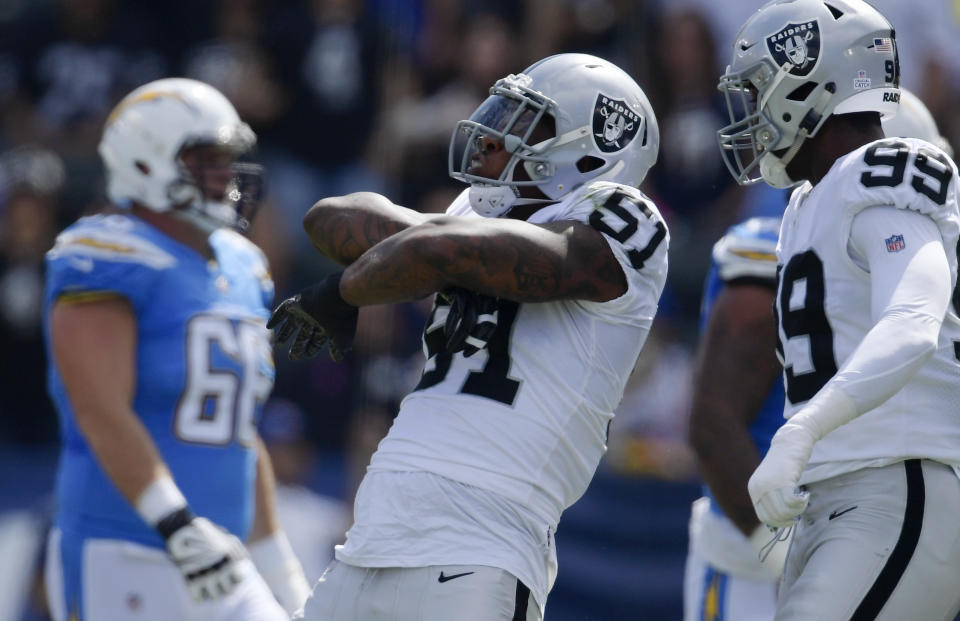 FILE - In this Oct. 7, 2018, file photo, Oakland Raiders defensive end Bruce Irvin, center, reacts after sacking Los Angeles Chargers quarterback Philip Rivers during the first half of an NFL football game in Carson, Calif. Irvin and the Raiders play the Seattle Seahawks this week in London. Irvin won a Super Bowl with Seattle. (AP Photo/Mark J. Terrill, File)