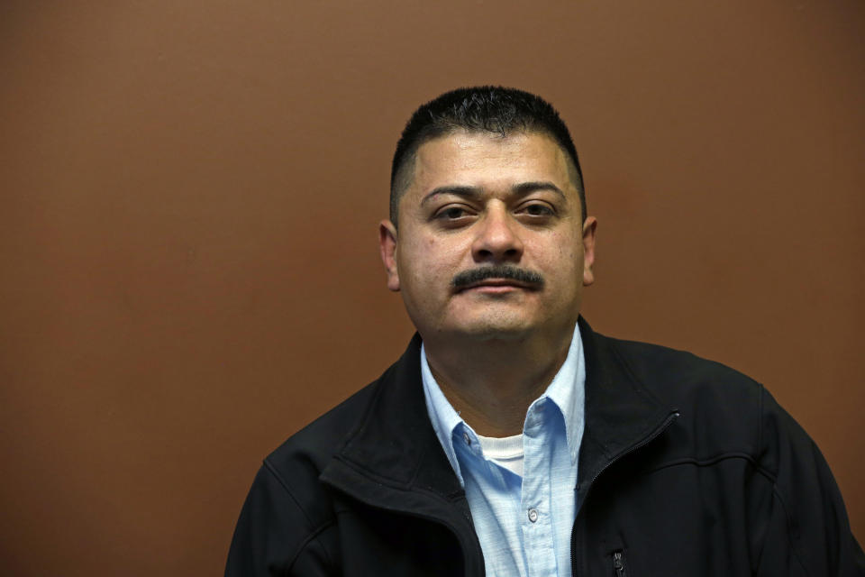 FILE - In this Oct. 17, 2014 file photo, Ignacio Lanuza sits for a portrait in Seattle. A federal judge on Tuesday, Oct. 29, 2019, criticized the Justice Department for seeking legal fees from Lanuza, a Mexican immigrant who was the victim of a forgery by a government lawyer. (AP Photo/Elaine Thompson, File)
