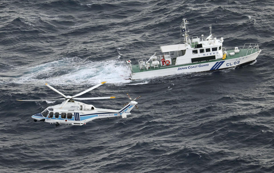 A Japan Coast Guard vessel and a helicopter conduct a search and rescue operation at the site where a U.S. Air Force V-22 Osprey aircraft crashed into the sea off Yakushima Island, Kagoshima prefecture, Japan, Nov. 30, 2023. / Credit: Kyodo via REUTERS