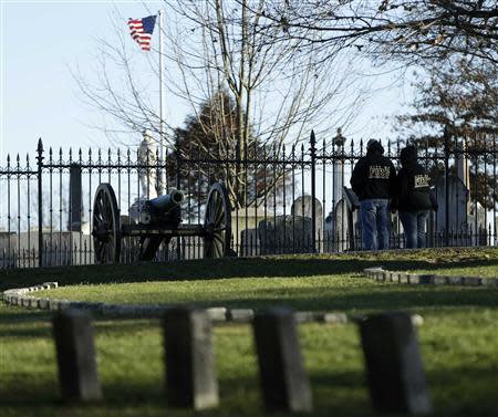 Visitors look at graves at the Gettysburg National Cemetery in Pennsylvania November 18, 2013. REUTERS/Gary Cameron