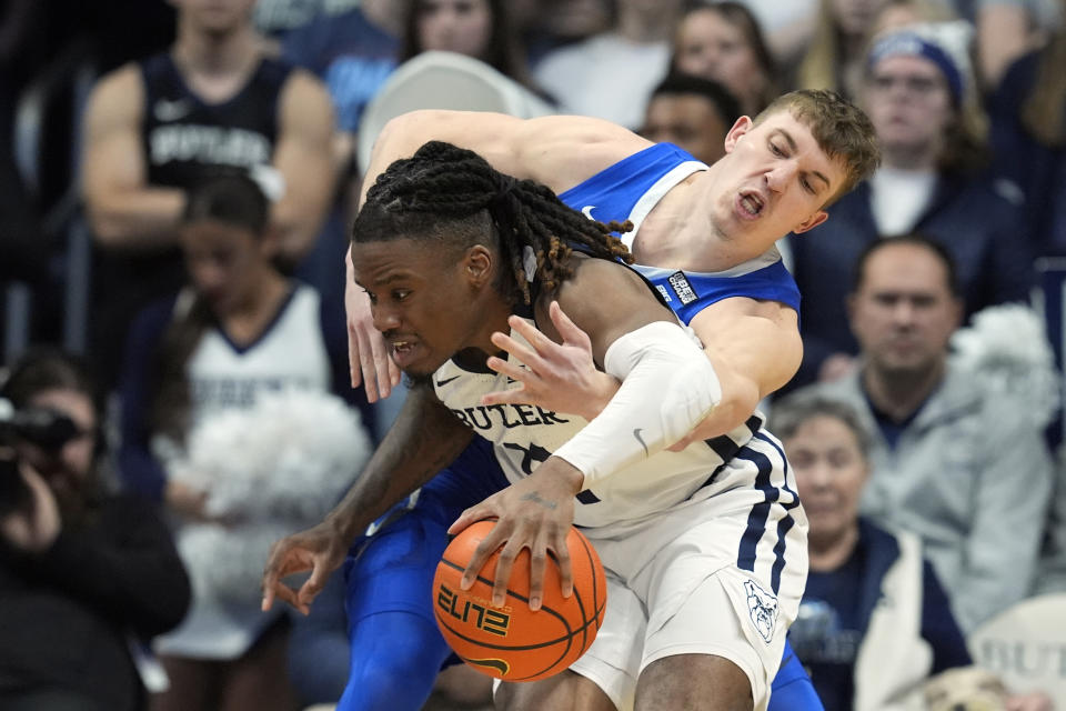 Creighton's Baylor Scheierman, rear, reaches in on Butler's Jahmyl Telfort (11) during the second half of an NCAA college basketball game, Saturday, Feb. 17, 2024, in Indianapolis. (AP Photo/Darron Cummings)