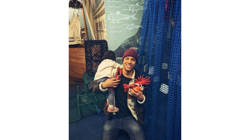 Will Kirk of Repair Shop fame holding his daughter and fish toys 