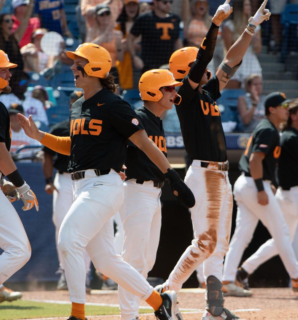 May 29, 2022; Hoover, AL, USA;  Tennessee players celebrate a three-run double by Tennessee outfielder Drew Gilbert (1) against Florida in the SEC Tournament Championship game at the Hoover Met in Hoover, Ala., Saturday. Mandatory Credit: Gary Cosby Jr.-The Tuscaloosa News