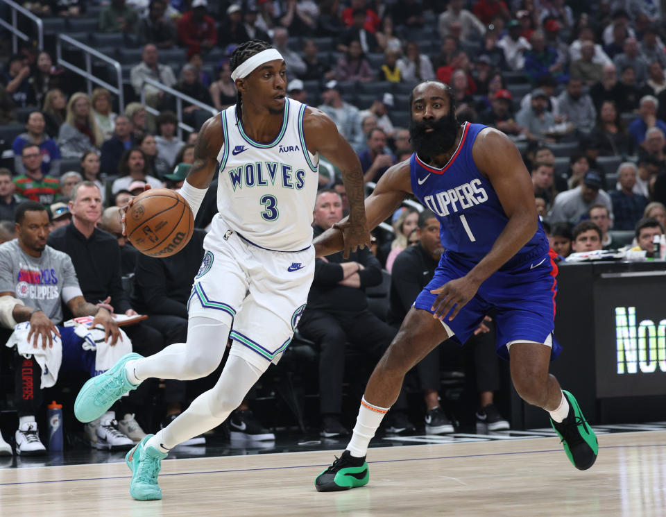 LOS ANGELES, CALIFORNIA - MARCH 12: Jaden McDaniels #3 of the Minnesota Timberwolves drives to the basket past James Harden #1 of the LA Clippers during a 118-100 Timberwolves win at Crypto.com Arena on March 12, 2024 in Los Angeles, California. (Photo by Harry How/Getty Images) User is consenting to the terms and conditions of the Getty Images License Agreement.