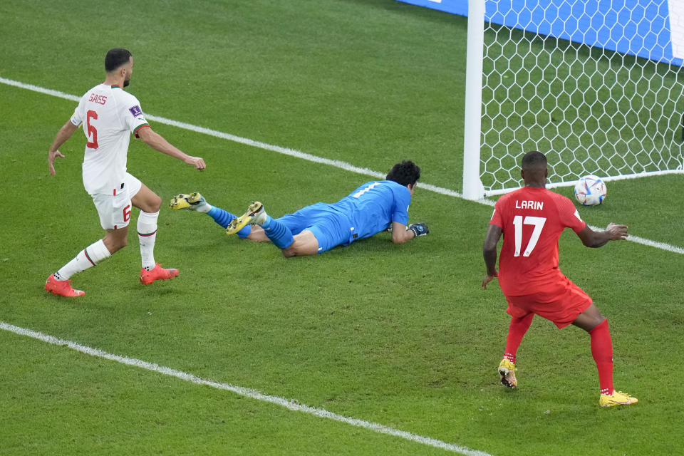 Morocco's goalkeeper Yassine Bounou, center, fails to stop an own goal by Morocco's Nayef Aguerd, not seen, as Canada's Cyle Larin and Morocco's Romain Saiss look on during the World Cup group F soccer match between Canada and Morocco at the Al Thumama Stadium in Doha , Qatar, Thursday, Dec. 1, 2022. (AP Photo/Alessandra Tarantino)