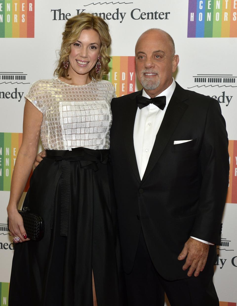 Pianist, singer-songwriter and multi-Grammy Award winner Billy Joel, 64, a 2013 Kennedy Center Honoree, poses with his girlfriend Alexis Roderick as they arrive at the U.S. State Department for a gala dinner, in Washington