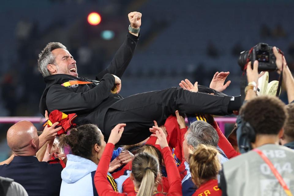 Vilda lifted up by his support staff and some players after Spain’s win (Getty)