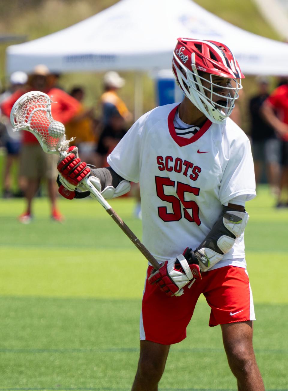 Dylan Faison scans the field looking to pass the ball during their game with Community School of Naples in a state lacrosse semifinal matchup on May 9 at the Paradise Coast Sports Complex in Naples.