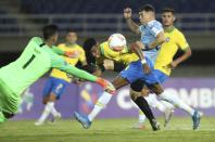 Brazil's Robson Bambu, center front, battles for the ball with Uruguay's Federico Vinas, second right, during a South America Olympic qualifying U23 soccer match at the Hernan Ramirez Villegas stadium in Pereira, Colombia, Wednesday, Jan. 22, 2020. (AP Photo/Fernando Vergara)