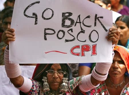 A supporter of Communist Party of India (CPI) holds a placard during a protest in Hyderabad June 24, 2011 against the planned construction of a $12 billion steel mill by South Korea's POSCO Odisha. REUTERS/Krishnendu Halder/Files