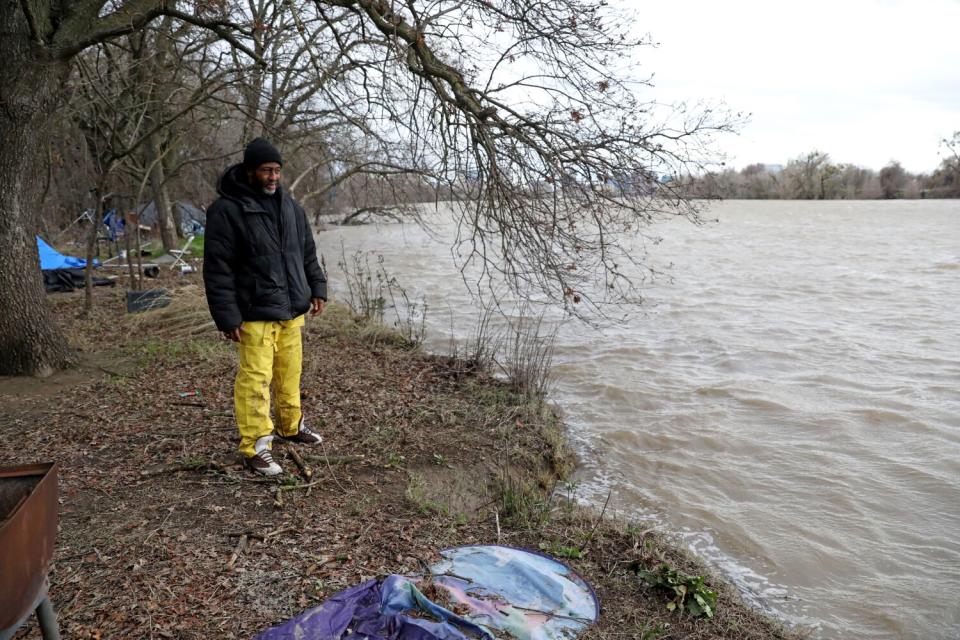 Woods checks the water level near the encampment.