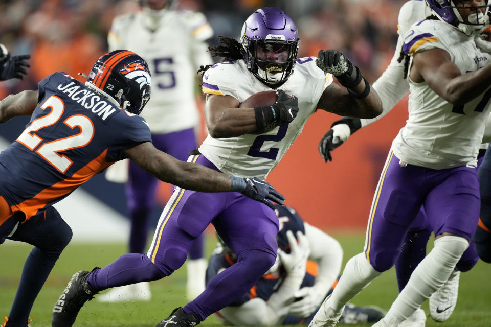 Minnesota Vikings running back Alexander Mattison (2) runs the ball against the Denver Broncos during the second half on an NFL football game, Sunday, Nov. 19, 2023, in Denver. (AP Photo/David Zalubowski)