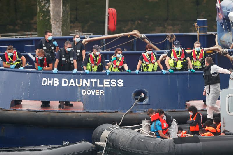 Migrants prepare to disembark at Dover harbour, in Dover