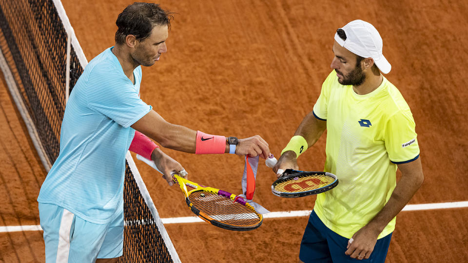 Rafael Nadal gives Stefano Travaglia the string dampener he had dropped, after beating him in the third round of the men's singles. (Photo by TPN/Getty Images)