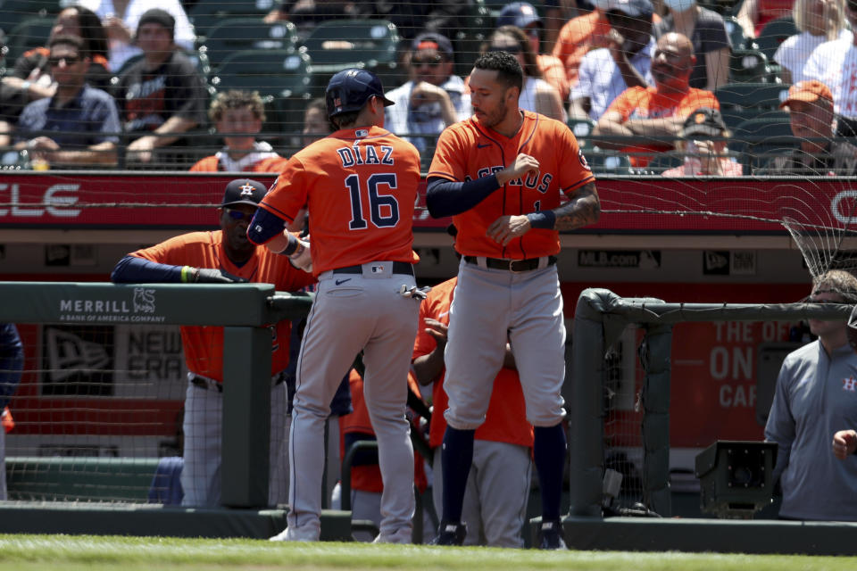 Houston Astros' Aledmys Diaz, left, is congratulated by teammate Carlos Correa after hitting a two-run home run against the San Francisco Giants during the third inning of a baseball game in San Francisco, Saturday, July 31, 2021. (AP Photo/Jed Jacobsohn)