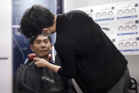 Yoshihiro Kamichi, a 44-year-old office worker, receives makeup and gets his hair done by a makeup artist at Ikemen-Works, a makeup salon for men, in Tokyo Wednesday, Feb. 3, 2021. The coronavirus pandemic has been pushing businesses to the edge in Japan, but some in the men's beauty industry have seen an unexpected expansion in their customer base. Japanese businessmen in their 40s, 50s and 60s who had little interest in cosmetics before the pandemic are now buying makeup. (AP Photo/Eugene Hoshiko)