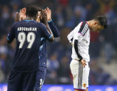 FC Basel's Behrang Safari (R) reacts at the end their Champions League round of 16 second leg soccer match against Porto at Dragao stadium in Porto, March 10, 2015. REUTERS/Miguel Vidal (PORTUGAL - Tags: SPORT SOCCER)