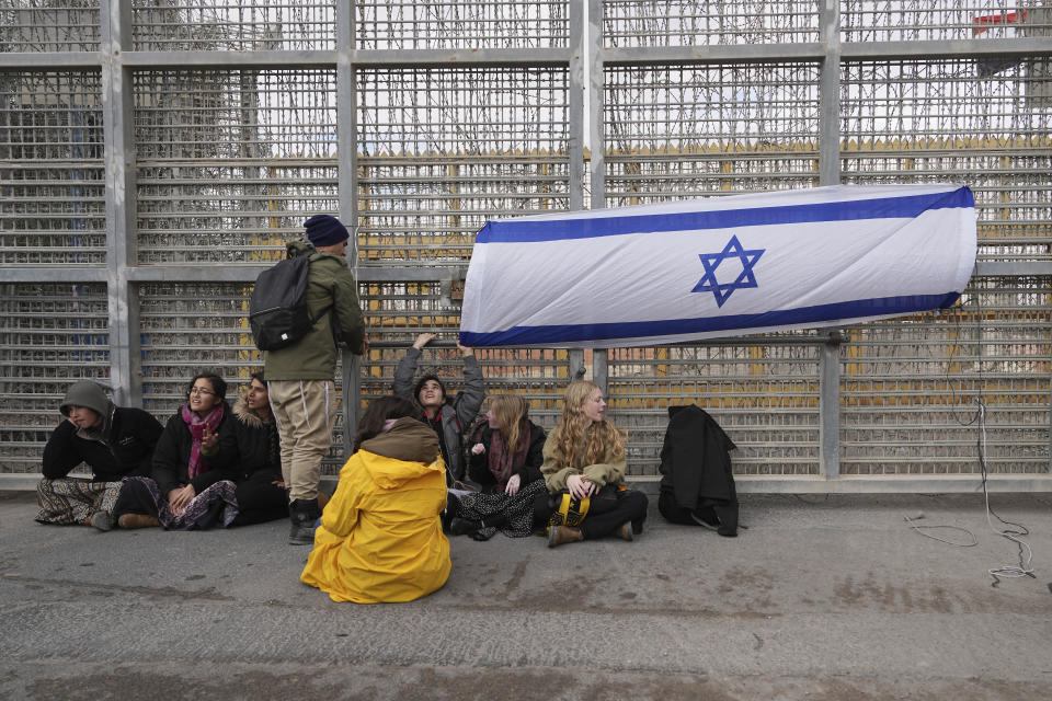 Protesters block the path for humanitarian aid bound for the Gaza Strip at the Nitzana border crossing with Egypt in southern Israel Friday, Feb. 2, 2024. (AP Photo/Tsafrir Abayov)