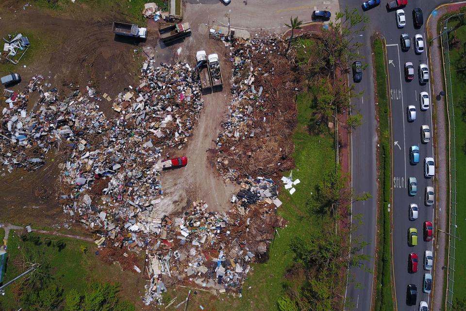 <p>Debris and garbage produced by the passing of Hurricane Maria are dumped in a field in Toa Baja, Puerto Rico on Oct. 6, 2017. (Photo: Ricardo Arduengo/AFP/Getty Images) </p>