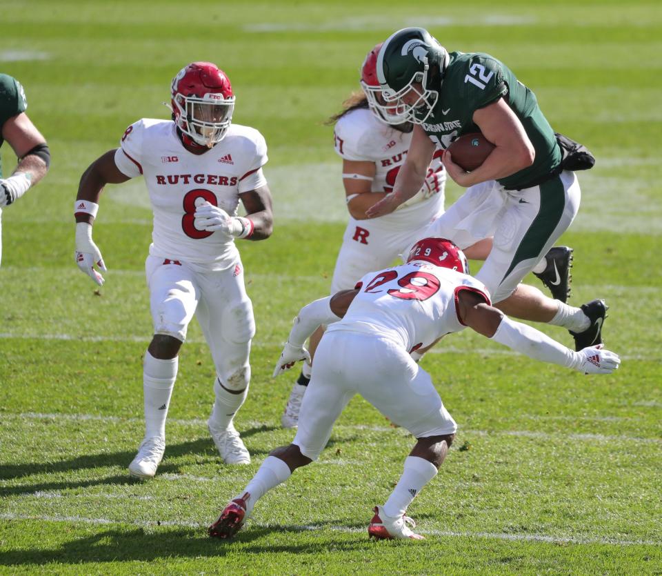 Michigan State quarterback Rocky Lombardi is tackled by Rutgers defensive back Lawrence Stevens during MSU's 38-27 loss on Saturday, Oct. 24, 2020, at Spartan Stadium.