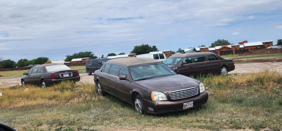 A group of old limousines await placement in the ground at the new Slug Bug Ranch Friday in Amarillo.
