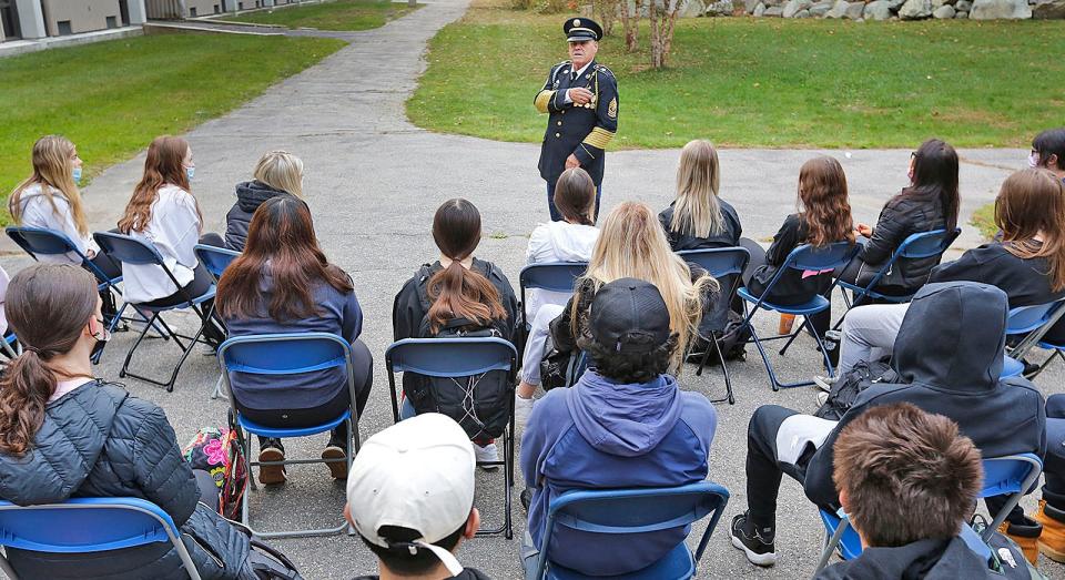 Retired U.S. Army 1st Sgt. John Bourne, of Rockland, talks with history students at Braintree High about his 27 years of service.