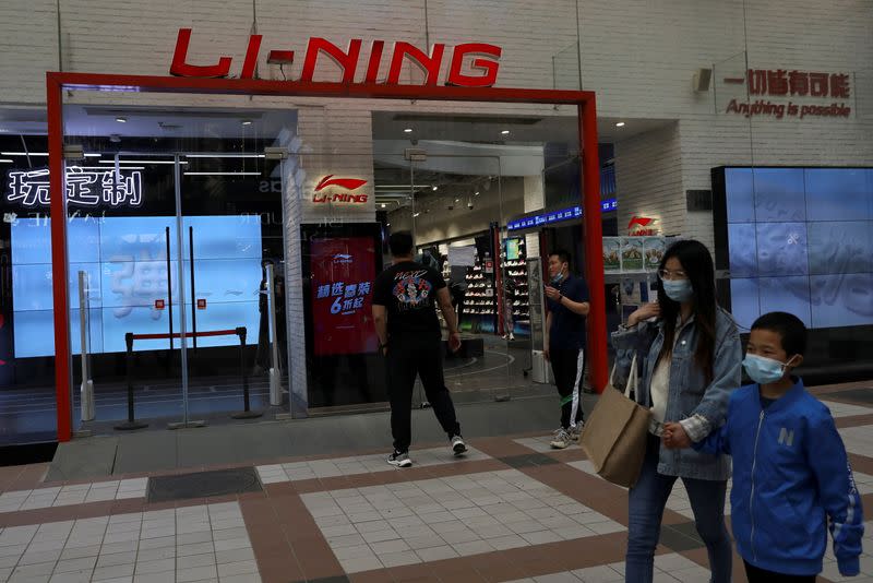 FILE PHOTO: People walk past a store of Chinese sports products brand Li Ning in Beijing