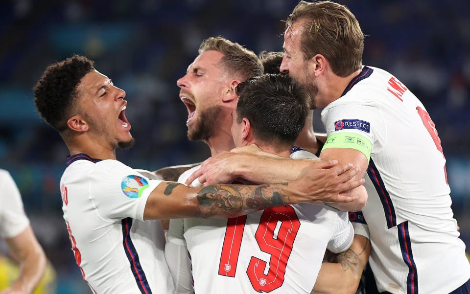 Jordan Henderson is mobbed by his team-mates after making it 4-0 to England - GETTY IMAGES