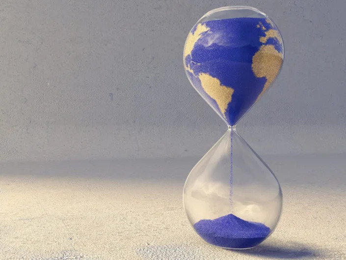 An hourglass with sands that look like Earth