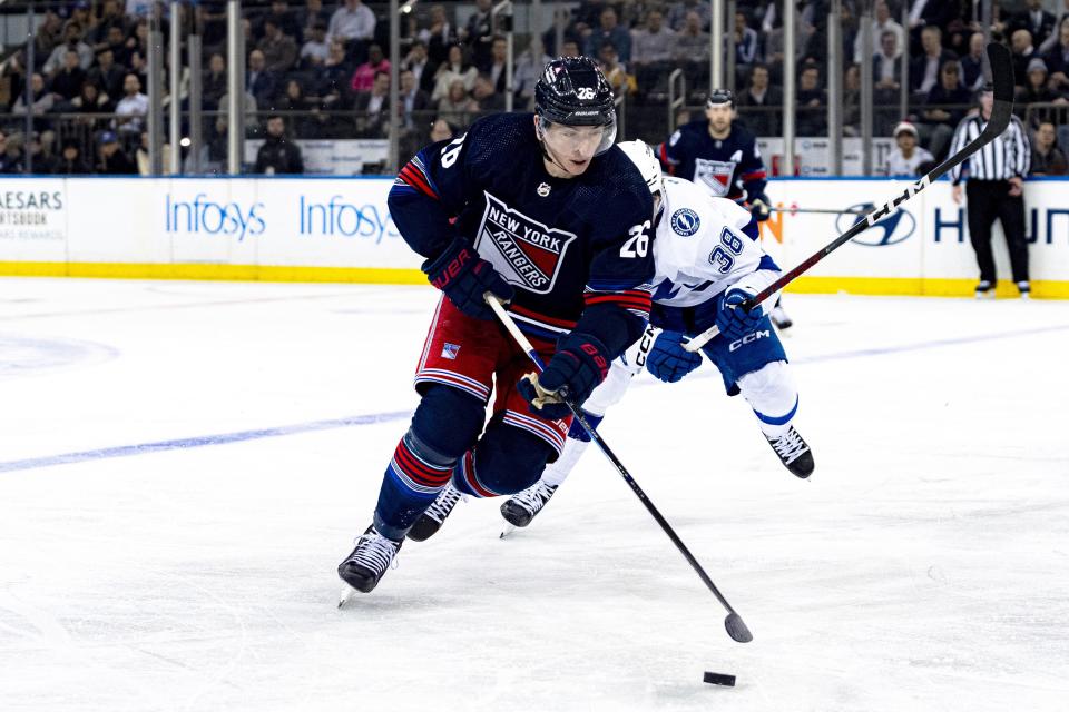 New York Rangers left wing Jimmy Vesey (26) is pursued by Tampa Bay Lightning left wing Brandon Hagel (38) during the first period of an NHL hockey game on Wednesday, Feb. 7, 2024 in New York. (AP Photo/Peter K. Afriyie)