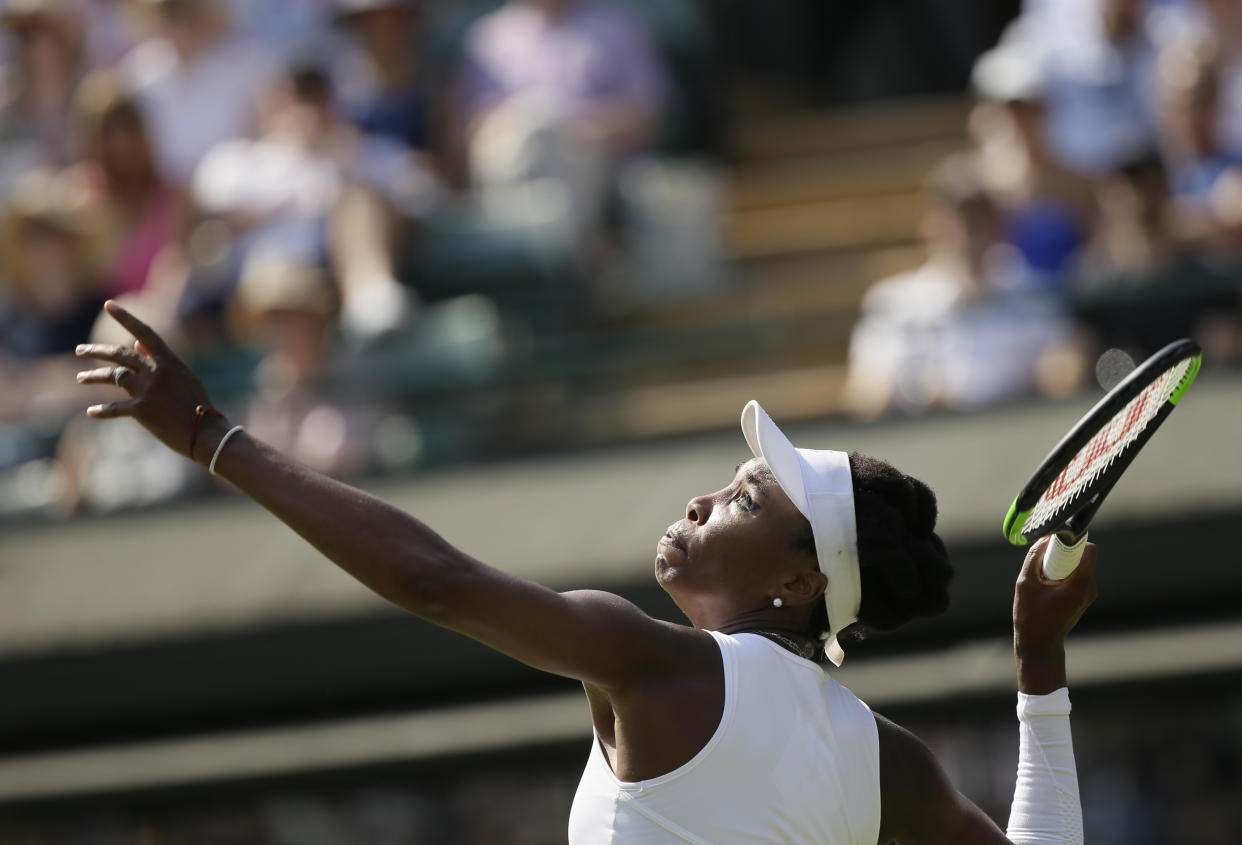 Venus Williams of the US serves to Kiki Bertens of the Netherlands during their men's singles match on the fifth day at the Wimbledon Tennis Championships in London, Friday July 6, 2018. (AP Photo/Tim Ireland)