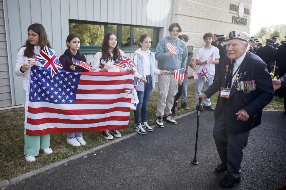 Children greet war veterans arriving for ceremony at the Pegasus Bridge memorial in Benouville, Normandy, Monday June 5, 2023. Dozens of World War II veterans have traveled to Normandy this week to mark the 79th anniversary of D-Day, the decisive but deadly assault that led to the liberation of France and Western Europe from Nazi control. (AP Photo/Thomas Padilla)