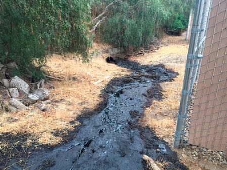 An estimated 700 barrels of crude oil spills from a broken pipeline in Ventura, California, U.S., in this handout photo posted on the Ventura County Fire Department's Twitter account and released to Reuters June 23, 2016. Ventura County Fire Department/Handout via Reuters