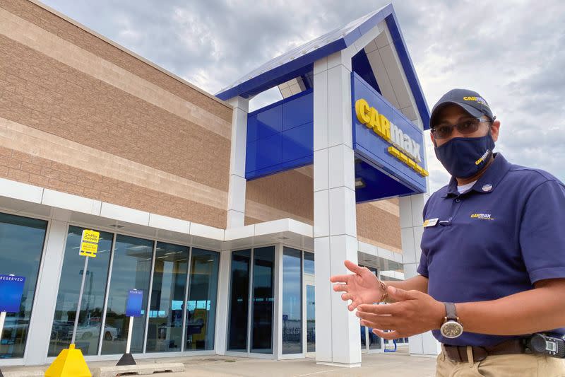 Brandon Parrum, general manager of CarMax's Des Moines store, shows where customers who arrange to buy a car on line can come for "contactless" curbside pickup