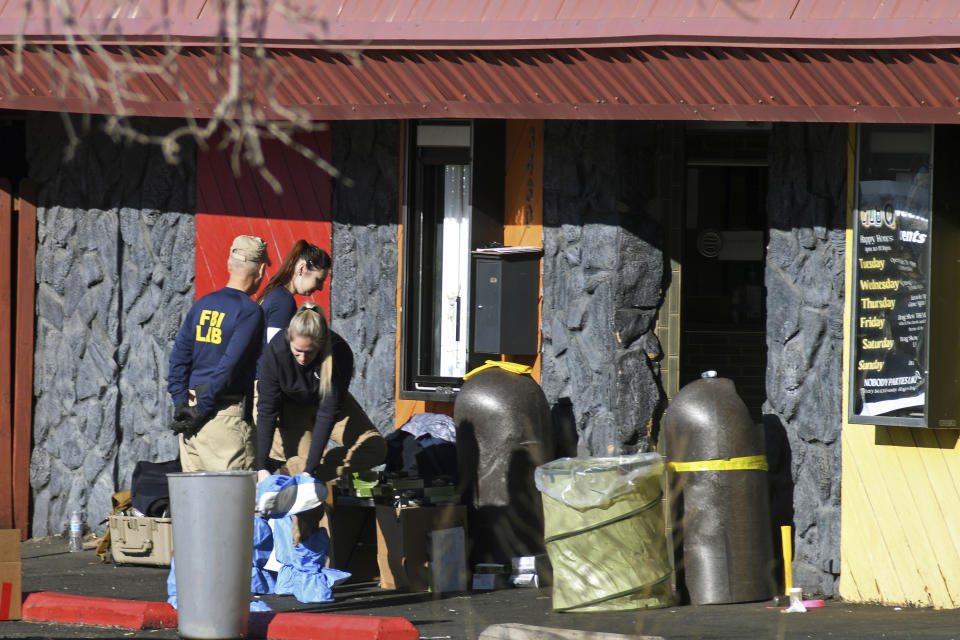 Crime scene investigators works outside of Club Q in Colorado Springs, Colo., on Tuesday, Nov. 22, 2022. Anderson Lee Aldrich opened fire at Club Q, on Saturday, in which five people were killed and others suffered gunshot wounds before patrons tackled and beat the suspect into submission. (AP Photo/Thomas Peipert)