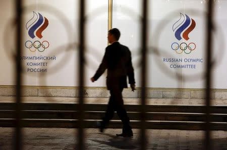 A man walks in front of the Russian Olympic Committee headquarters building, which also houses the management of Russian Athletics Federation in Moscow, Russia, November 13, 2015. REUTERS/Sergei Karpukhin