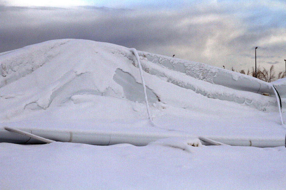 Accumulated snow sits on the collapsed roof of The Dome, a 180,000-square foot indoor sports facility in Anchorage, Alaska, on Tuesday, Jan. 24, 2017, after the roof collapsed in the midst of a snowstorm. The facility is among others, including an old lumber mill in Oregon, the main grocery store in a small Idaho town, and a conference center in Colorado that have collapsed under the accumulated weight of snow this winter. (AP Photo/Mark Thiessen)