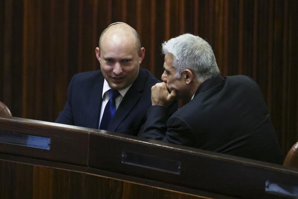 Naftali Bennett, left, speaks with Yair Lapid.