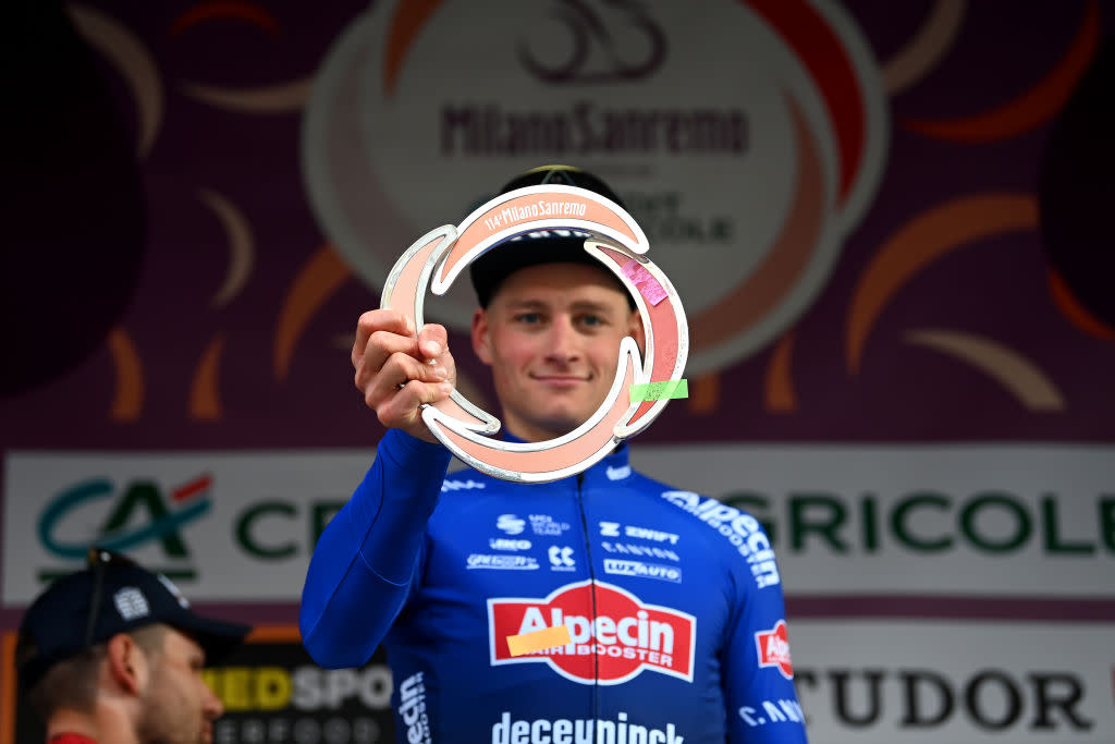  SANREMO ITALY  MARCH 18 Mathieu Van Der Poel of The Netherlands and Team AlpecinDeceuninck celebrates at podium as race winner holding the trophy during the 114th MilanoSanremo 2023 a 294km one day race from Abbiategrasso to Sanremo  MilanoSanremo  UCIWT  on March 18 2023 in Sanremo Italy Photo by Tim de WaeleGetty Images 