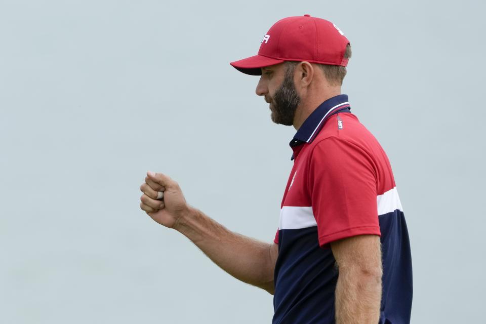 Team USA's Dustin Johnson reacts after his putt on the third hole during a Ryder Cup singles match at the Whistling Straits Golf Course Sunday, Sept. 26, 2021, in Sheboygan, Wis. (AP Photo/Charlie Neibergall)