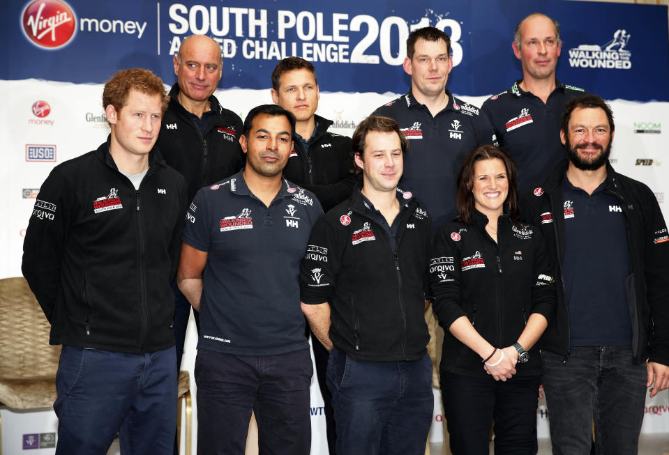 Britain's Prince Harry, left, the Expedition Patron, poses with members of the Walking With The Wounded South Pole Allied Challenge 2013 team, following a welcome home news conference, in central London, Tuesday, Jan. 21, 2014. The Walking With The Wounded Virgin Money South Pole Allied Challenge 2013 concluded on Friday 13 December, when three teams of wounded servicemen and women successfully reached the South Pole after crossing 200km of Antarctic plateau. (AP Photo/Lefteris Pitarakis, Pool)