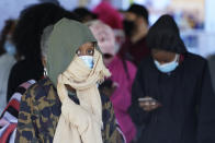 Voters brave a chilly and windy morning to cast their ballots early Friday, Oct. 30, 2020, in Covington, Ga. (AP Photo/John Bazemore)