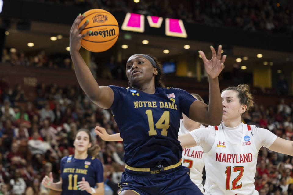 Notre Dame's KK Bransford (14) goes for a rebound over Maryland's Elisa Pinzan (12) in the second half of a Sweet 16 college basketball game of the NCAA Tournament in Greenville, S.C., Saturday, March 25, 2023. (AP Photo/Mic Smith)