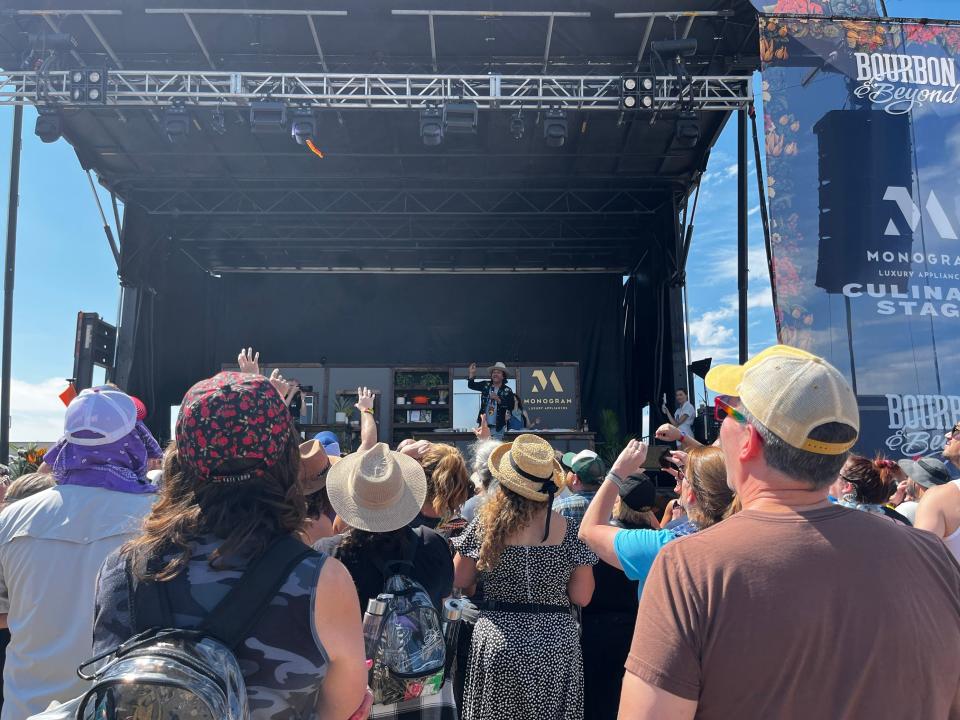 Chef Ed Lee threw a piece of crispy bacon into the audience during a cooking demonstration Saturday at Bourbon & Beyond.