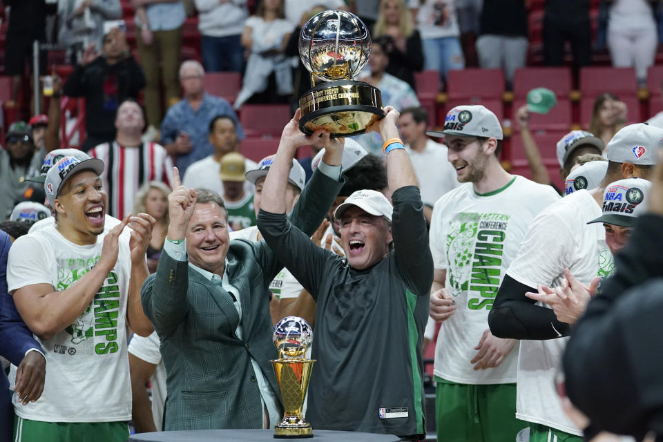Boston Celtics managing partner and CEO Wycliffe Grousbeck raised the NBA Eastern Conference trophy after defeating the Miami Heat in Game 7 of the NBA basketball Eastern Conference finals playoff series, Sunday, May 29, 2022, in Miami. (AP Photo/Lynne Sladky)